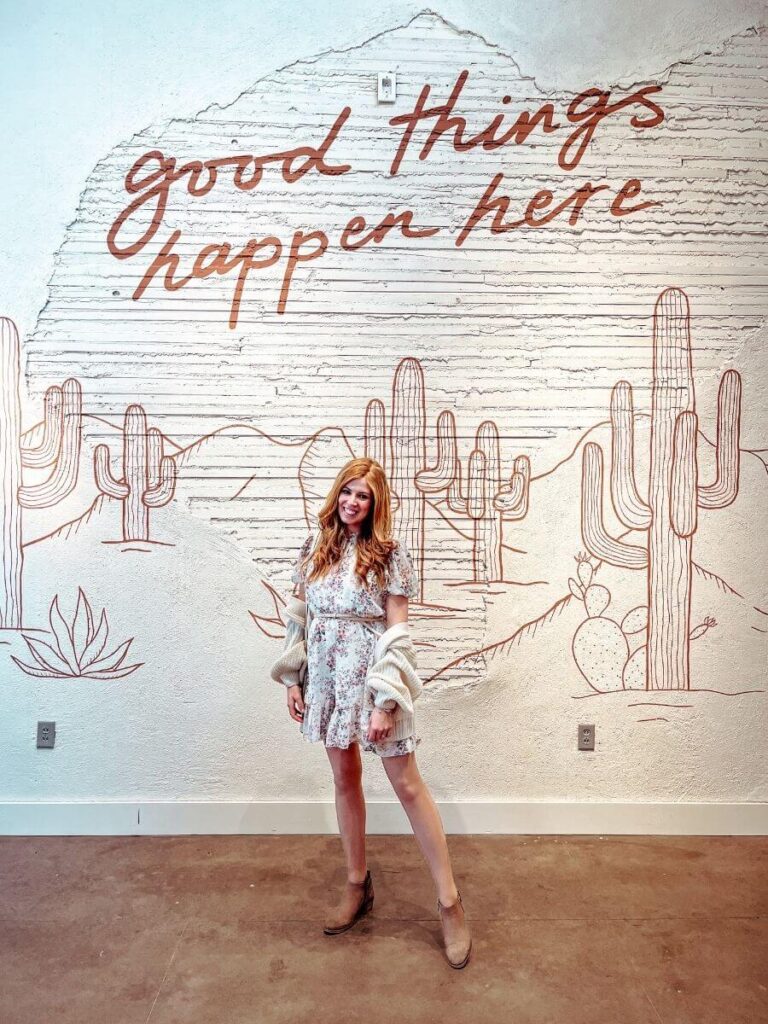Posing by a mural in the Fleastyle shop in Stockyards Fort Worth