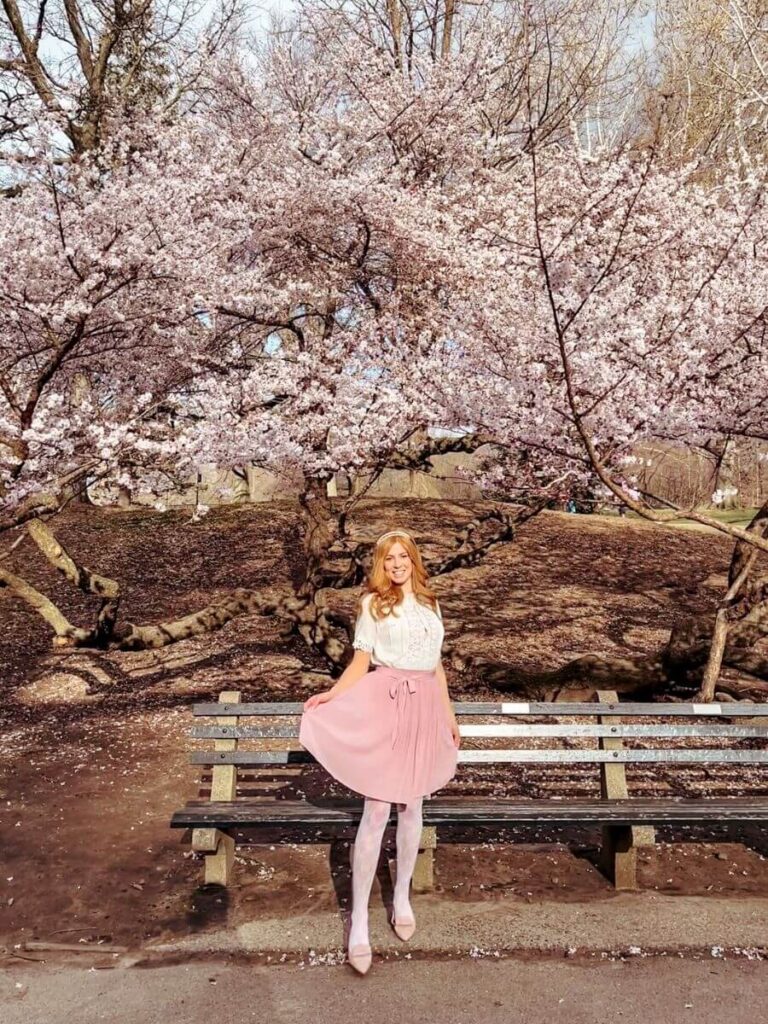 Posing in front of beautiful blossom tree in the park. 