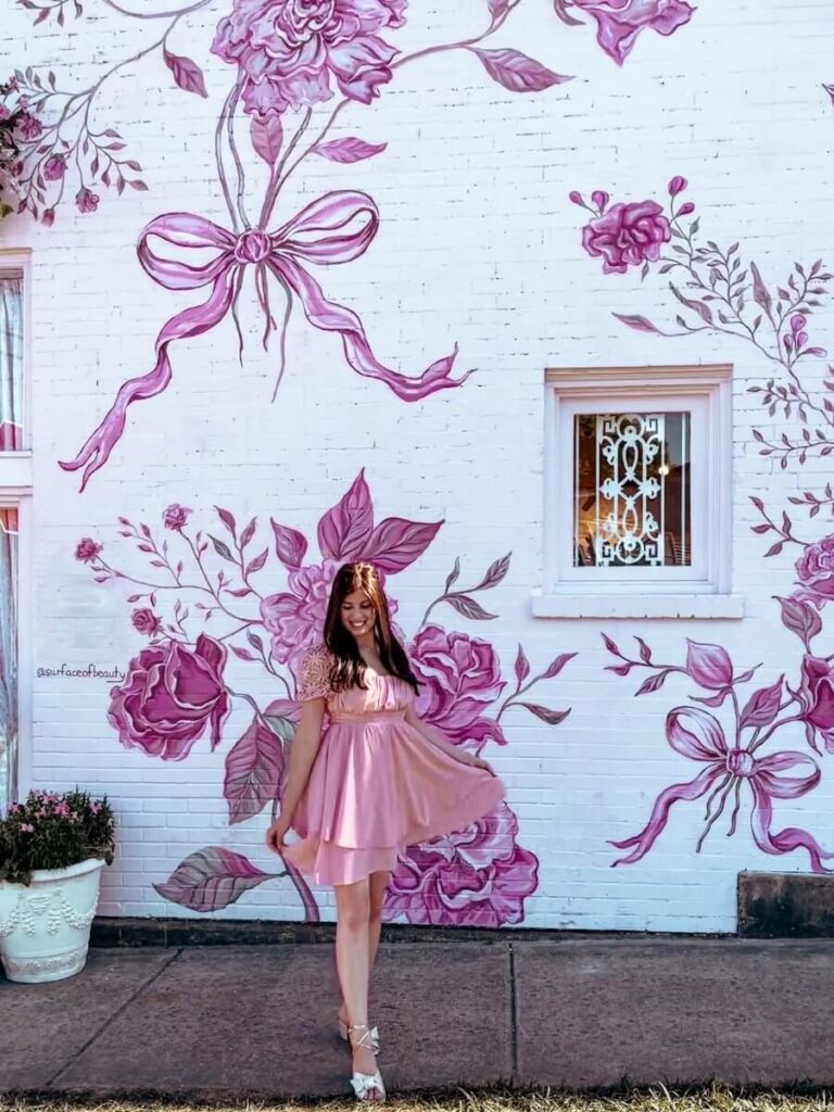 Outside Loveshackfancy Nashville – pastel pink wall is a dreamy Nashville photo spot

