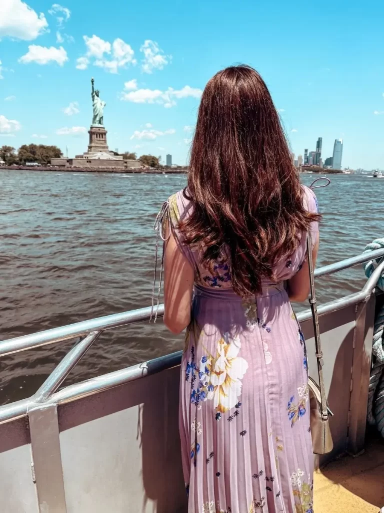 Mum in the City looking at the view of the Statue of Liberty from a NYC whale watching cruise ship