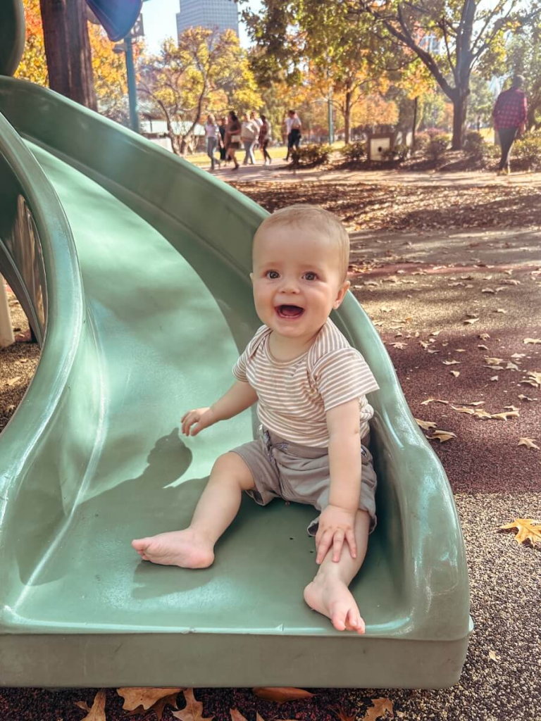 Toddler playing on a slide at Centennial Olympic Park playground in Atlanta