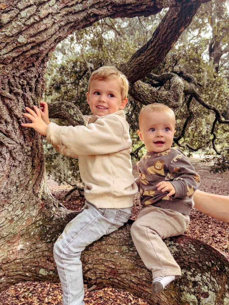Children enjoying tree climbing in Hampton Park, a fun photo spot in Charleston for families.