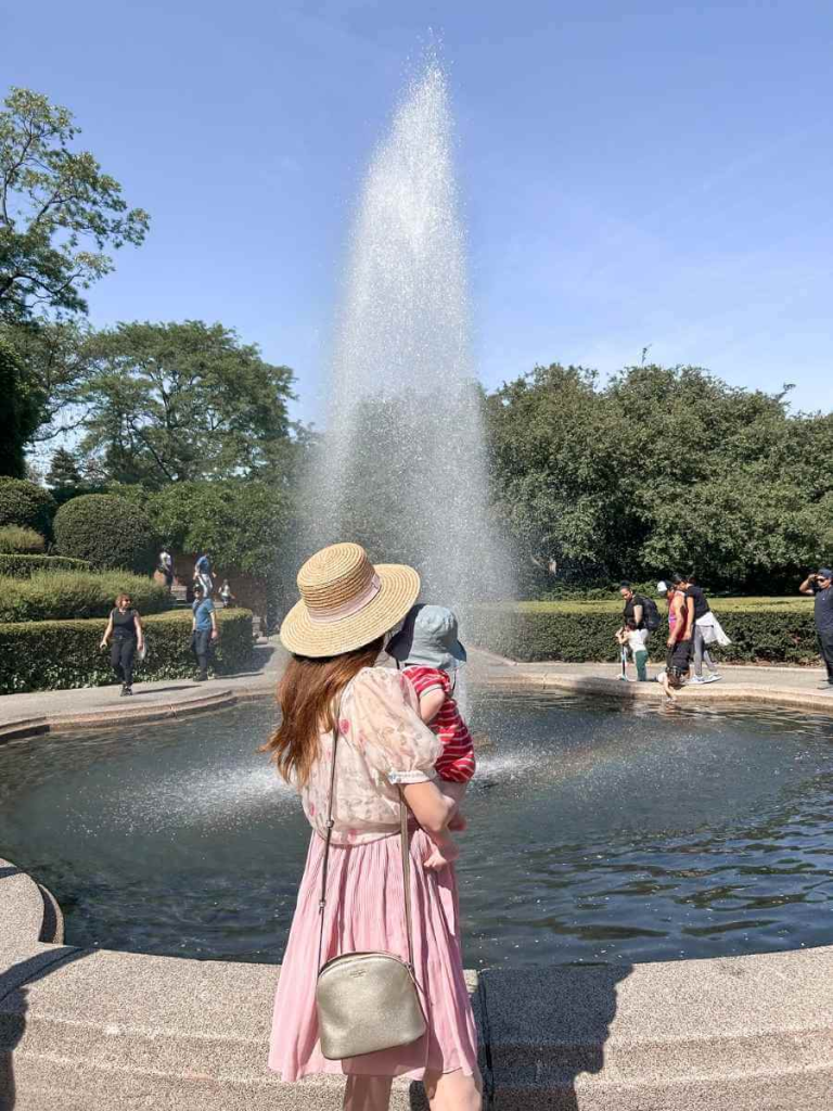 Mum in the City and her baby watching the fountain in Conservatory Gardens. A perfect are in Central Park for a stroller walk.