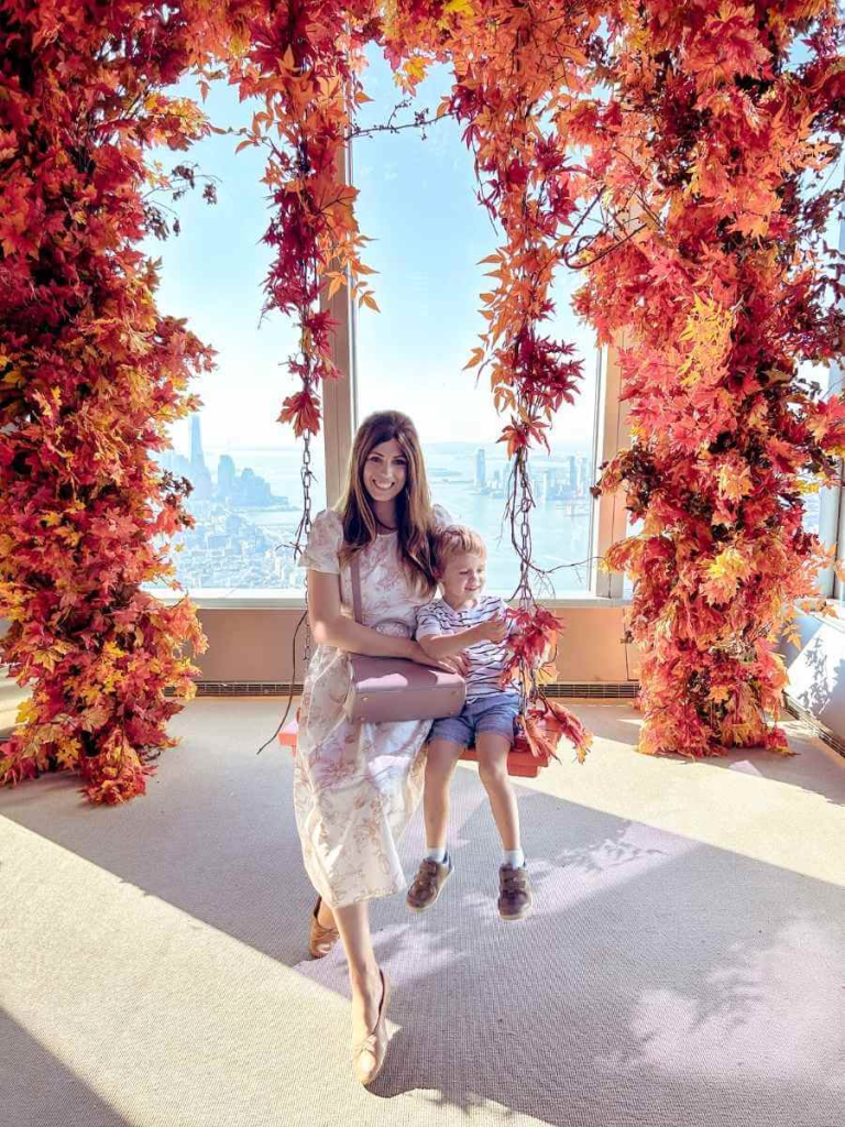 Seasonal fall floral swing display at The Edge NYC — one of New York’s most popular observation decks