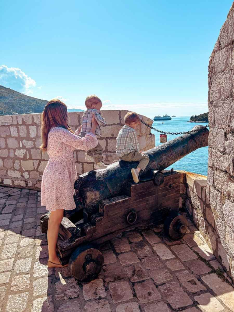 Playing on the canons while walking the Dubrovnik City Walls with kids