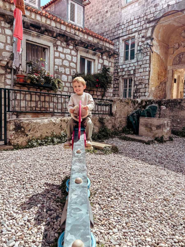 enjoying a playground in Dubrovnik. A fun and free thing to do with toddlers.