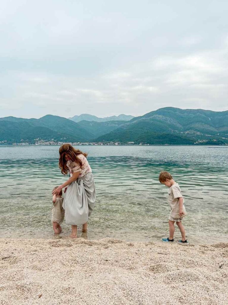 Family enjoying Tivat beach with stunning sea and mountain views in Montenegro