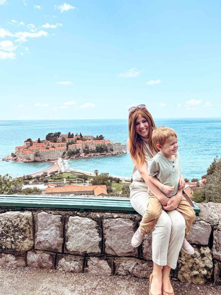 Mother and son at iconic Sveti Stefan viewpoint overlooking the Adriatic coast in Montenegro