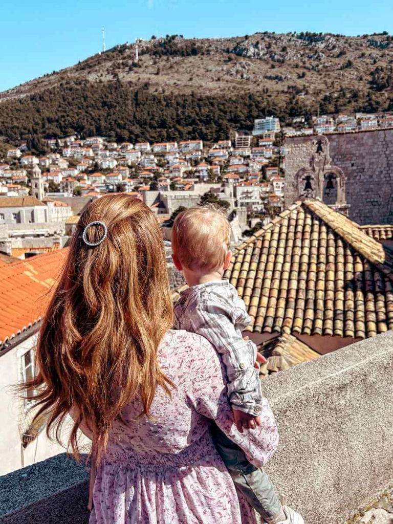 Mum in the City and her baby looking at the view of Dubrovnik from the city walls.