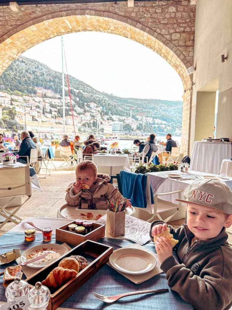 Children dining at Gradska Kavana Arsenal in Dubrovnik with harbour views — family-friendly restaurant in Old Town