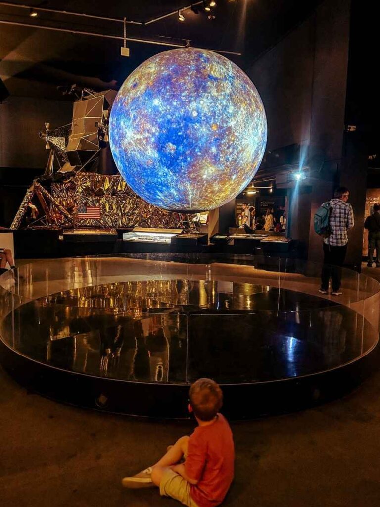 Large illuminated globe in the Space Gallery at the Science Museum London, part of the space-themed exhibits for children.