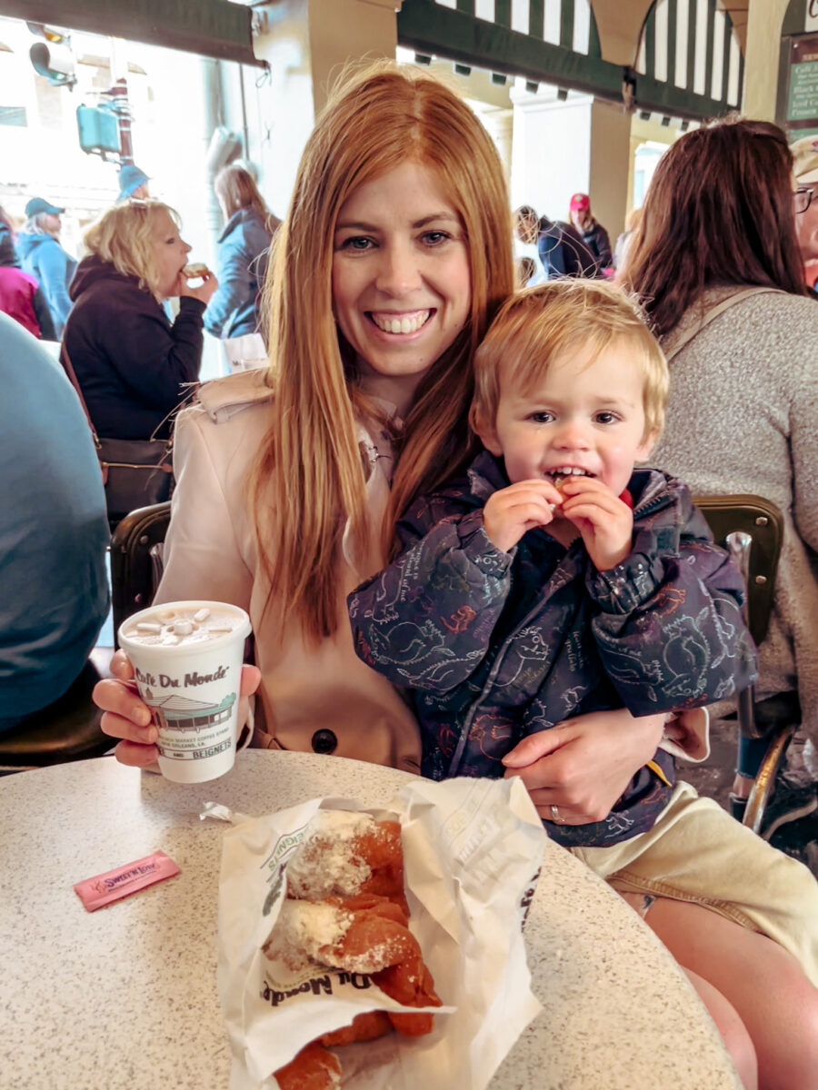Mum in the City and her son enjoying coffee and beignets at Cafe du Monde. A must do activity on a family vacation in New Orleans.