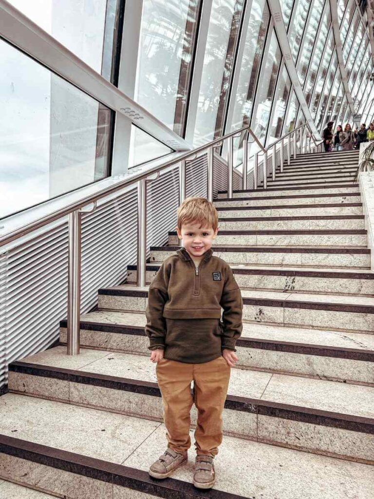 Young child on the stairs inside the Sky Garden, exploring the family-friendly space