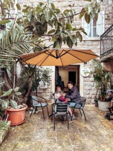 Sitting outside Café Beatrice Budva enjoying breakfast on a rainy morning