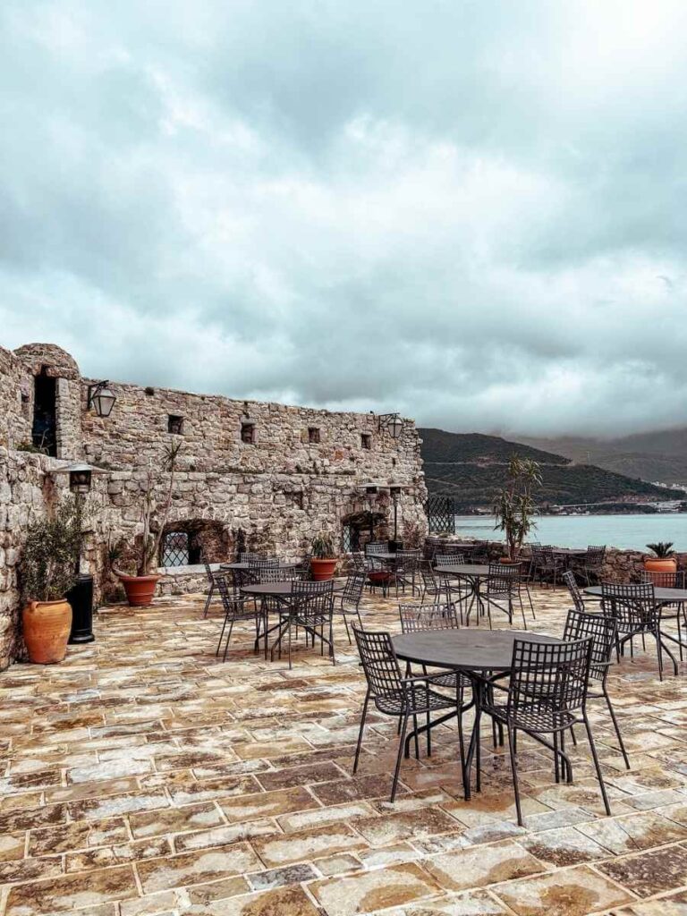 Outdoor café at the Budva Citadel offering scenic views of the sea.