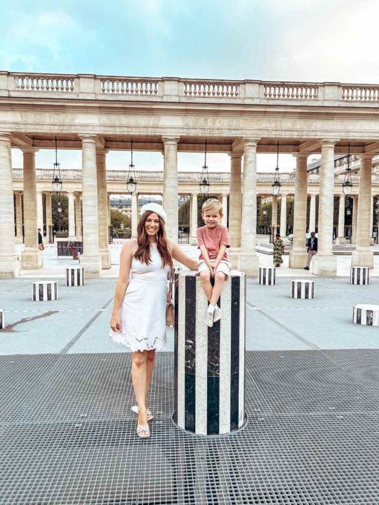 Mother and son posing on a Buren column, a fun family photo spot in central Paris