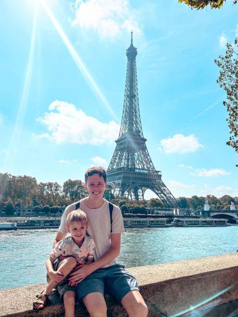 View of the Eiffel Tower from the River Seine banks, a peaceful stroller-friendly spot in Paris with a toddler