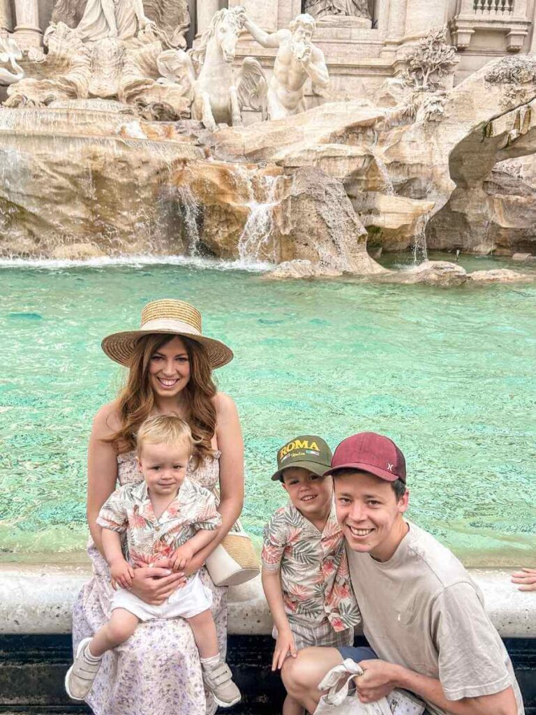 Family posing in front of the Trevi Fountain in Rome during 3 days in Rome Italy
