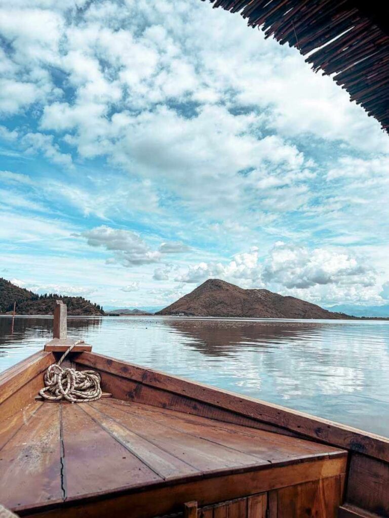 View from the front of the boat with mountains in the background on a Skadar Lake tour