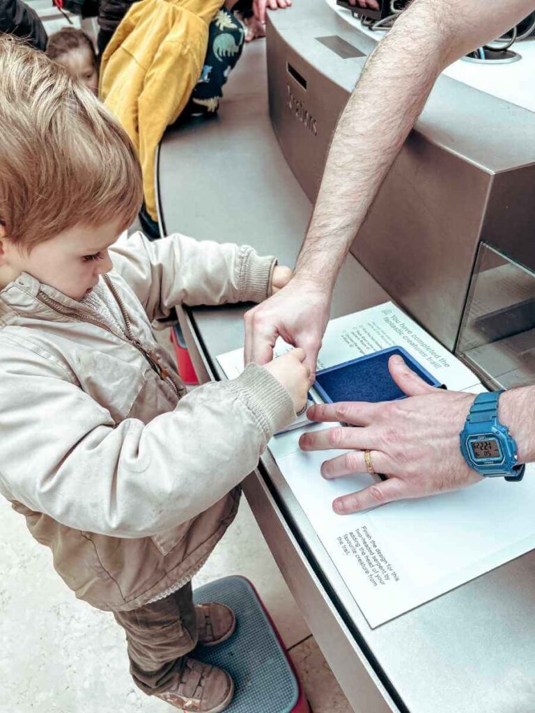 British Museum staff stamping a completed children’s activity booklet