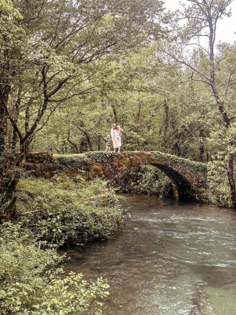 Family crossing the stone bridge at the end of the Dupalo hiking trail in Virpazar