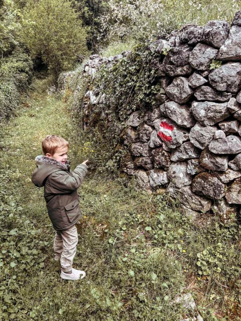 Young child excited at the start of the Dupalo hiking trail near Virpazar, Montenegro