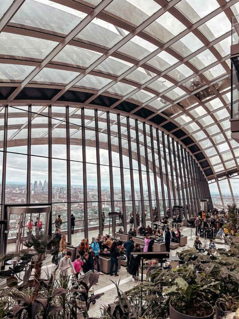 Lush greenery and glass roof interior of the Sky Garden in London