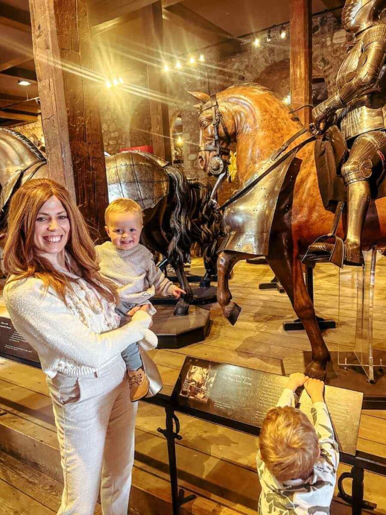 Family looking at a suit of armour on display at the Tower of London