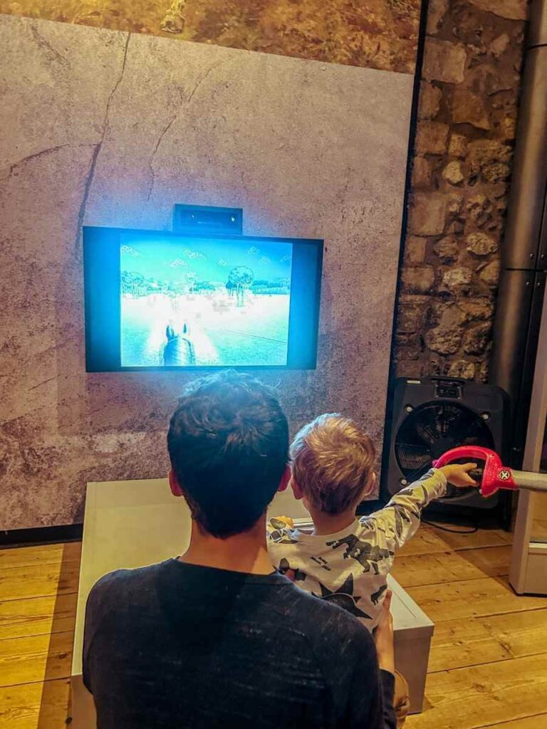 Young child playing with an interactive exhibit at the Tower of London museum