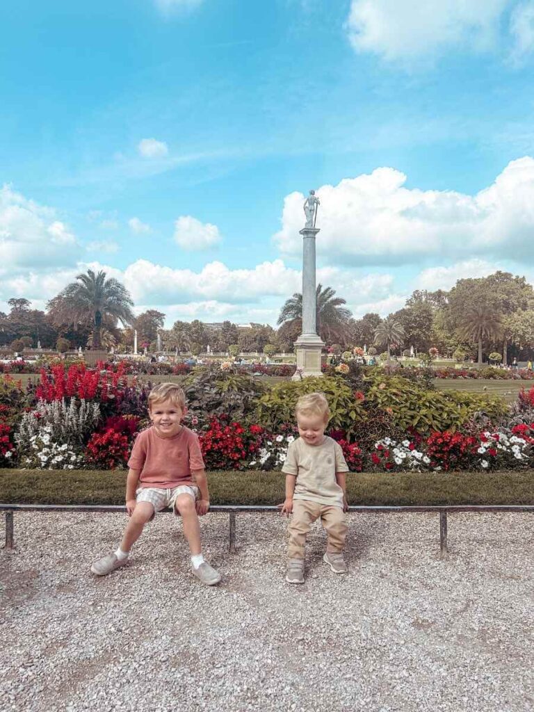 Children sitting by the colourful flowerbeds in the Luxembourg Gardens