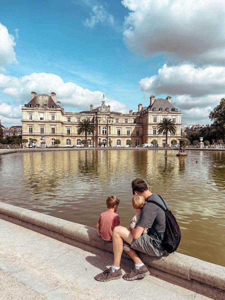 Family sat by the pond at Jardin du Luxembourg