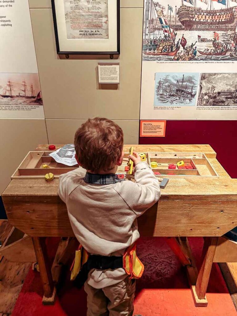 Child Playin gon an activity table at the Museum of London Docklands, one of the best museums for kids in London.
