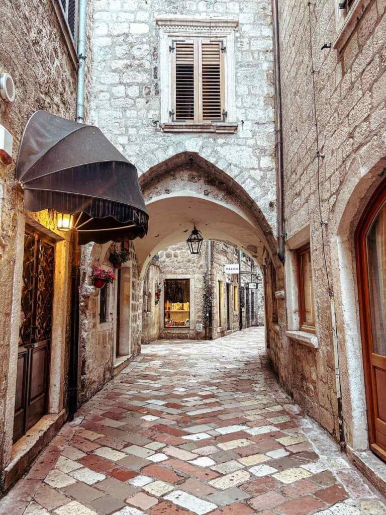 Charming narrow street lined with stone buildings in Old Town Kotor.