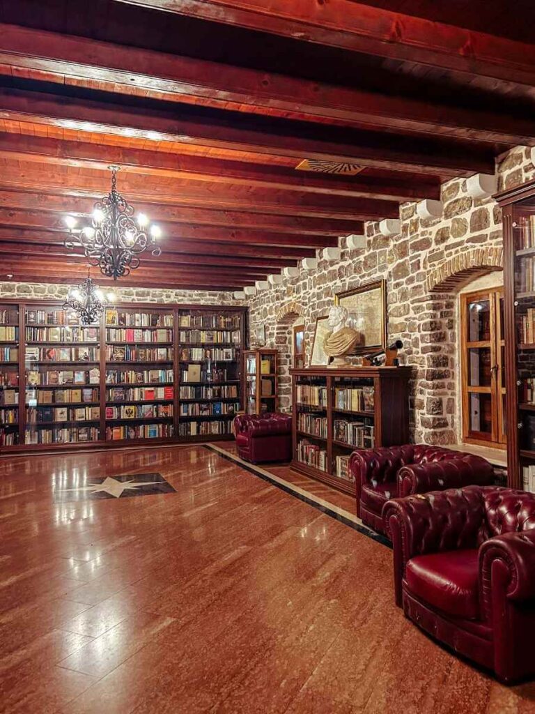 Interior of the Budva Citadel library with wooden shelves, books, and historic charm