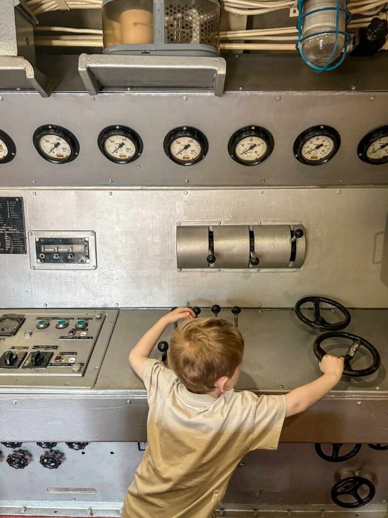 My son pretending to steer the submarine using the original control wheels inside