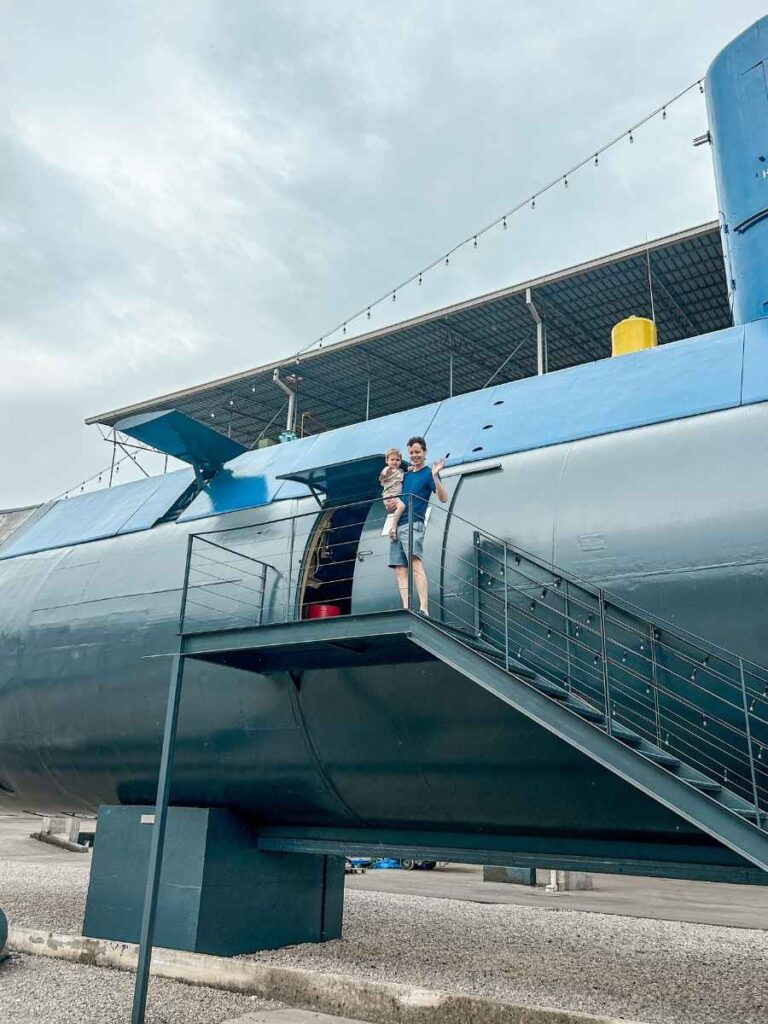 My husband and son posing next to the retired submarine on display in Tivat