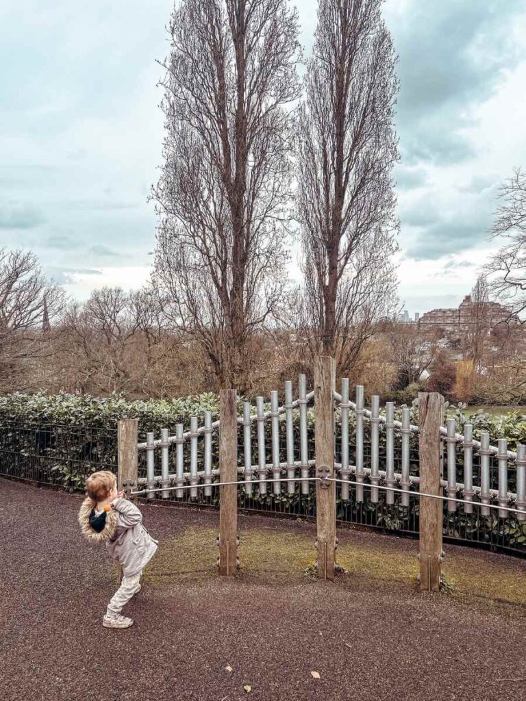 Child playing an oversized outdoor instrument in the Horniman Museum’s music garden – fun and educational for kids