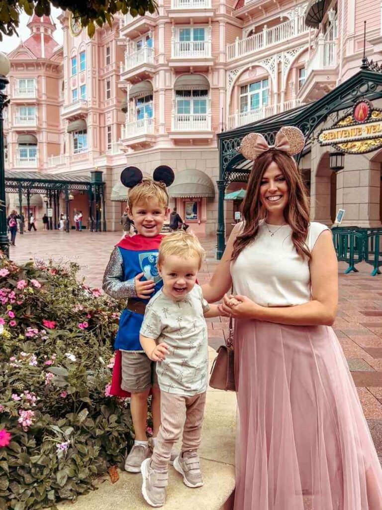 Family with two young children outside Disneyland Hotel Paris – perfect for staying close to the park.