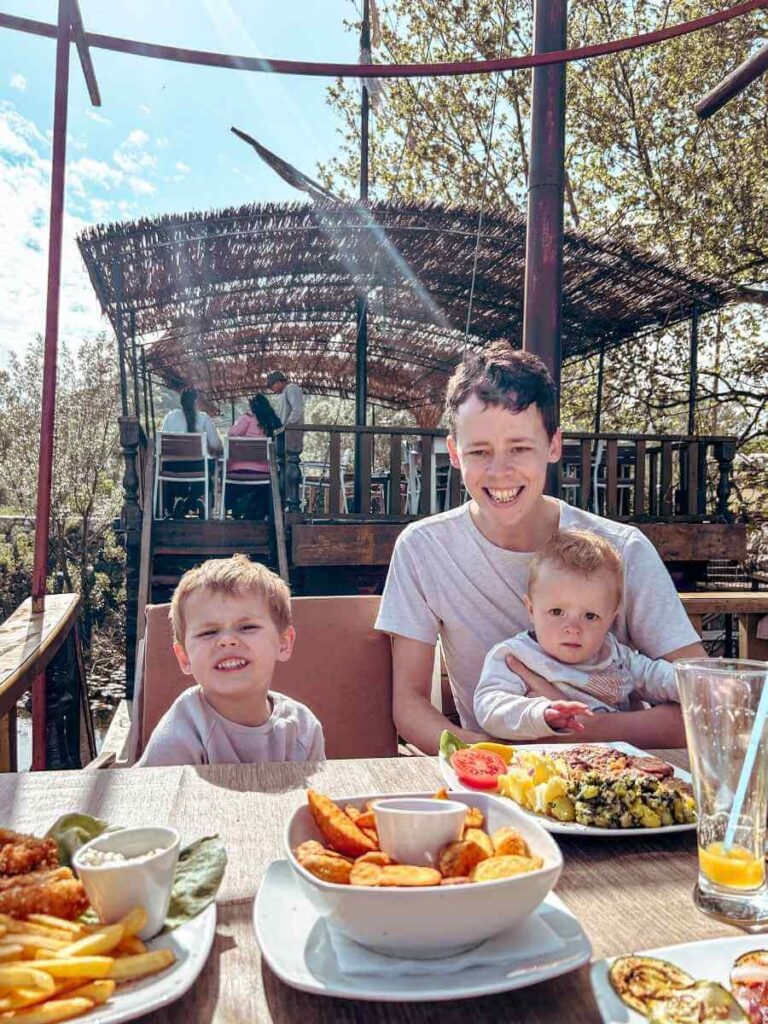 Family dining at a floating restaurant in Virpazar, overlooking Lake Skadar