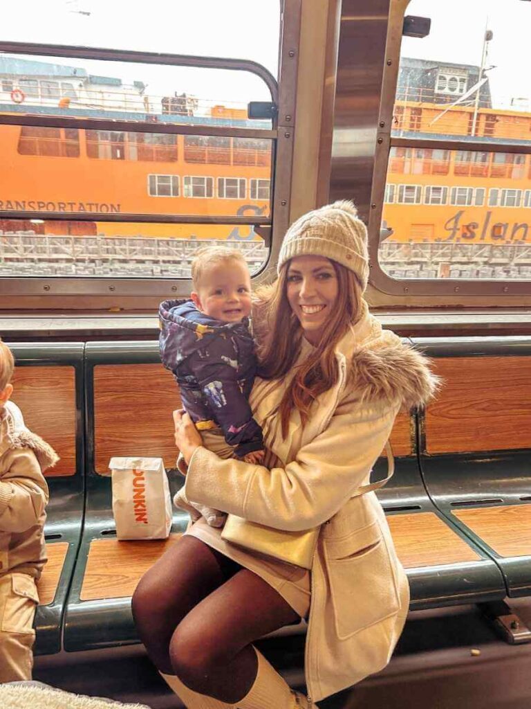 Family riding the Staten Island Ferry with views of the Statue of Liberty
