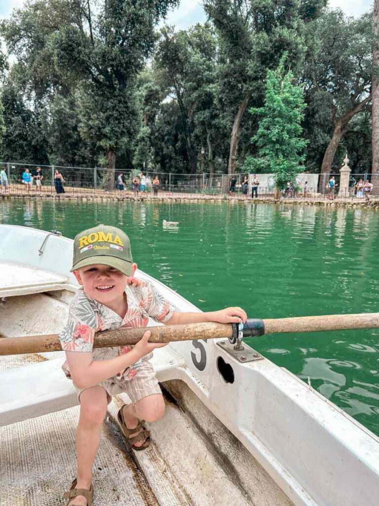 Child enjoying a boat ride surrounded by greenery in Villa Borghese during 3 days in Rome Italy