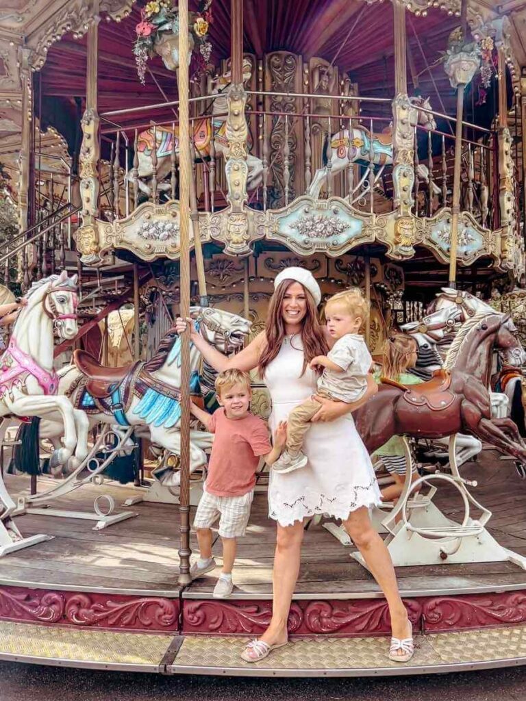 Beautiful vintage carousel in Montmartre with painted horses and ornate detail, add this to your Paris with a toddler itinerary!