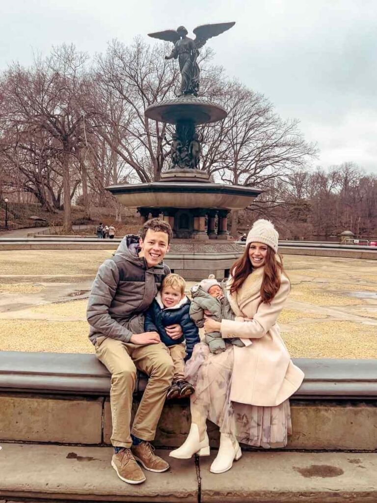 Our family sitting beside Bethesda Fountain in Central Park, enjoying the relaxing atmosphere on our 4 days in New York with kids itinerary. 
