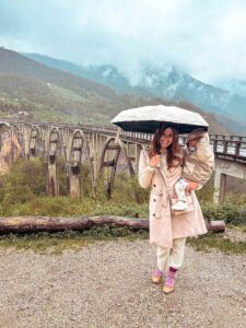 Mother and baby at Tara Canyon with Đurđevića Tara Bridge in the background, Montenegro family trip. A must visit on your 2 week Montenegro itinerary.