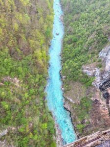 Aerial view of Tara Canyon and the Tara River surrounded by forested mountains in Montenegro