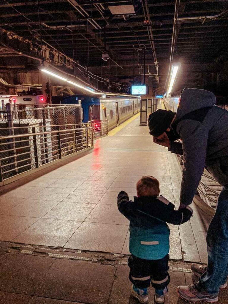 My son watching trains inside Grand Central during our family itinerary