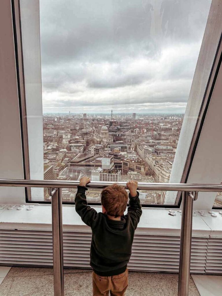 Young boy admiring views of London from the Sky Garden observation deck