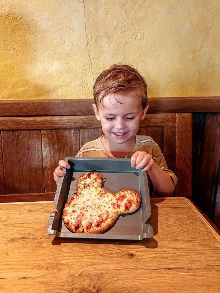 Mickey Mouse-shaped kids’ pizza at Disneyland Paris – fun toddler-friendly food option.