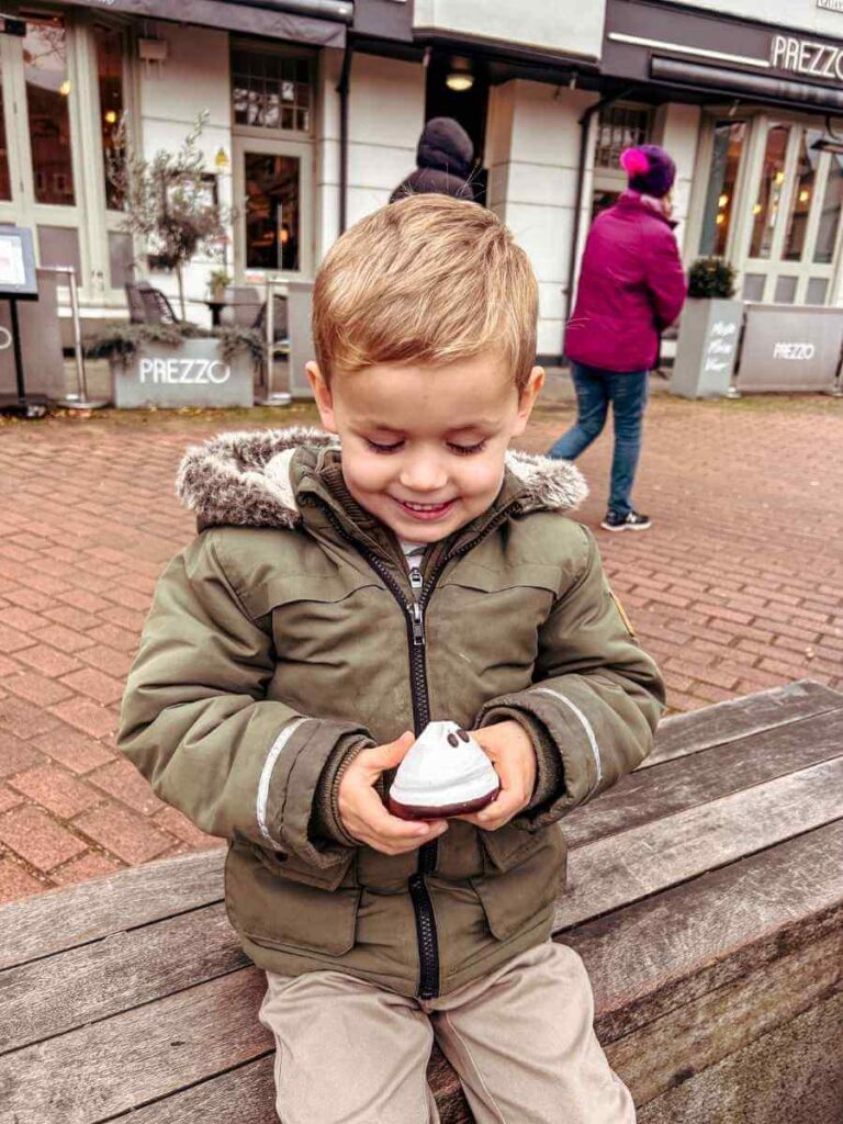 Child enjoying a delicious treat from Fitzbillies bakery – one of the fun foodie things to do in Cambridge with kids.