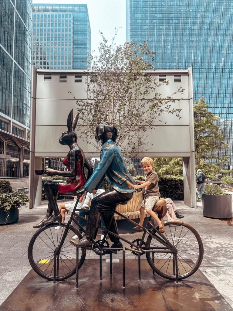 Riding an animal bike sculpture on the Children's Art trail around Canary Wharf